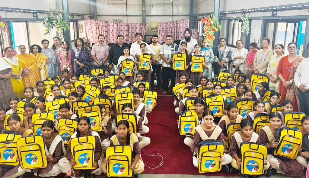 MLA Brahm Shankar Jimpa distributes school bags to girl students of Government Girls Senior Secondary School Railway Mandi